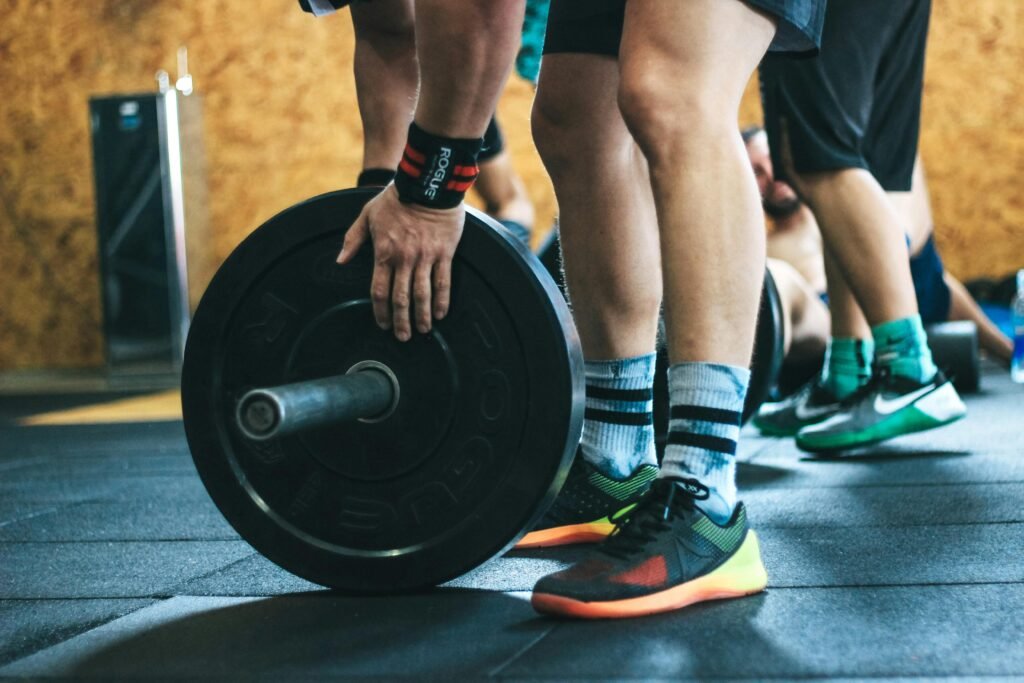 Close-up of a person lifting a barbell during a workout at a gym.